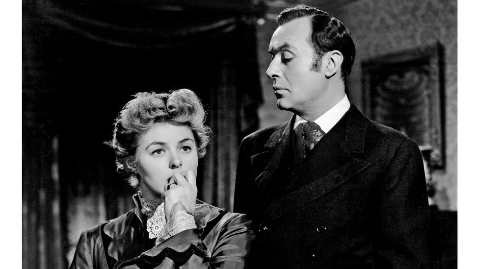 Cena em preto e branco do filme À Meia Luz (1944), com Ingrid Bergman como Paula e Charles Boyer como seu marido manipulador, Gregory.